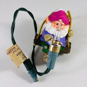 Adorable little Christmas elf holding a light bulb very vintage